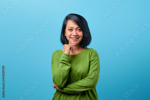 Attractive Asian woman wearing casual clothes smiling looking interested © Sewupari Studio