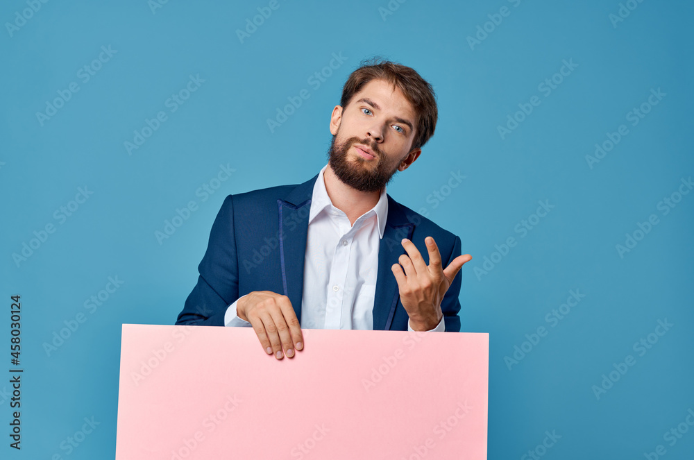 Cheerful man pink paper in the hands of marketing fun Lifestyle isolated background Cheerful man pink paper in the hands of marketing fun Lifestyle isolated background