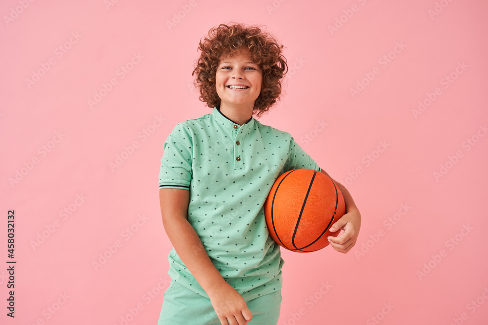 Little caucasian boy smiling happiness and posing with orange ball Little caucasian boy smiling happiness and posing with orange ball