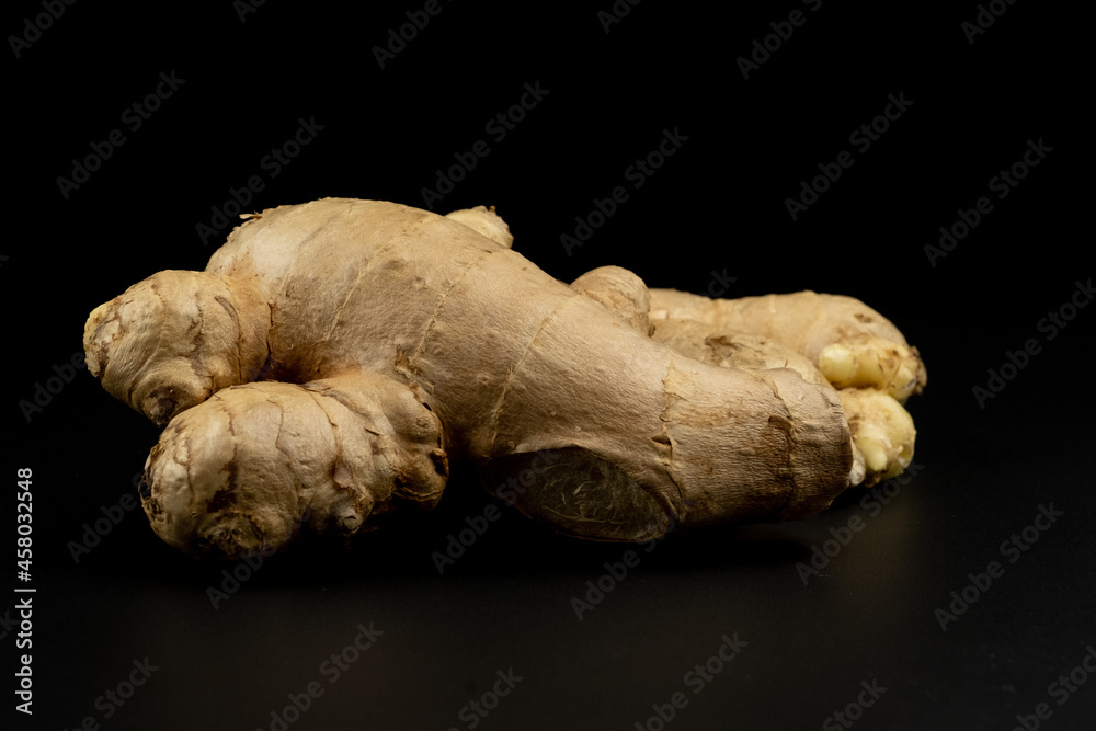 Whole group pile ingredient of fresh ginger group isolated on black background