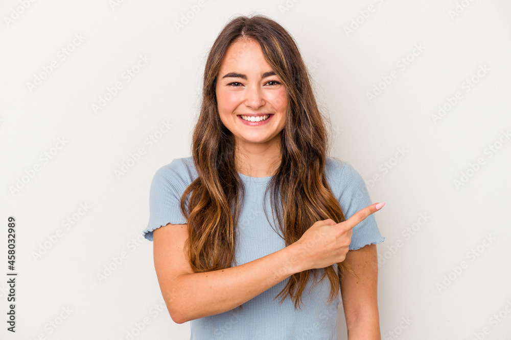 Young caucasian woman isolated on white background smiling and pointing aside, showing something at blank space. Young caucasian woman isolated on white background smiling and pointing aside, showing something at blank space.