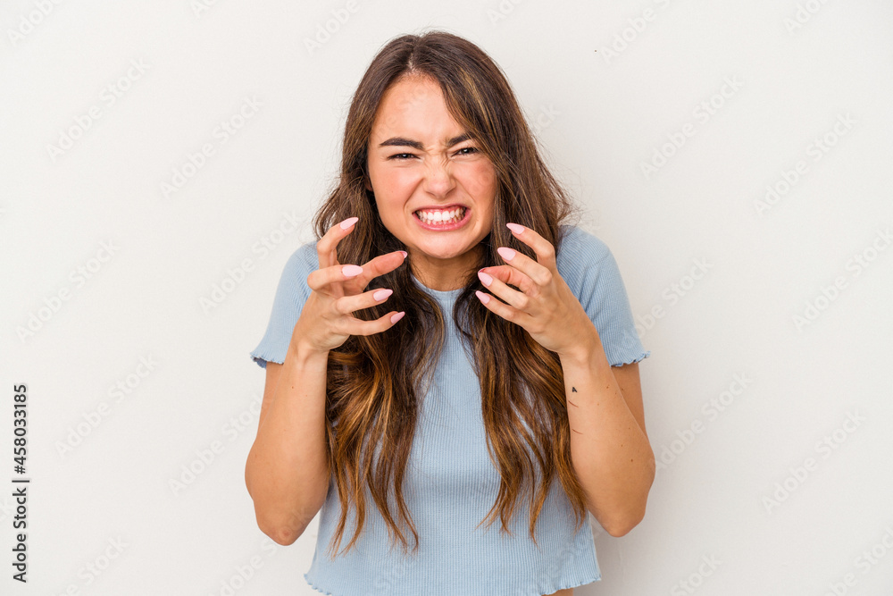 Young caucasian woman isolated on white background upset screaming with tense hands. Young caucasian woman isolated on white background upset screaming with tense hands.