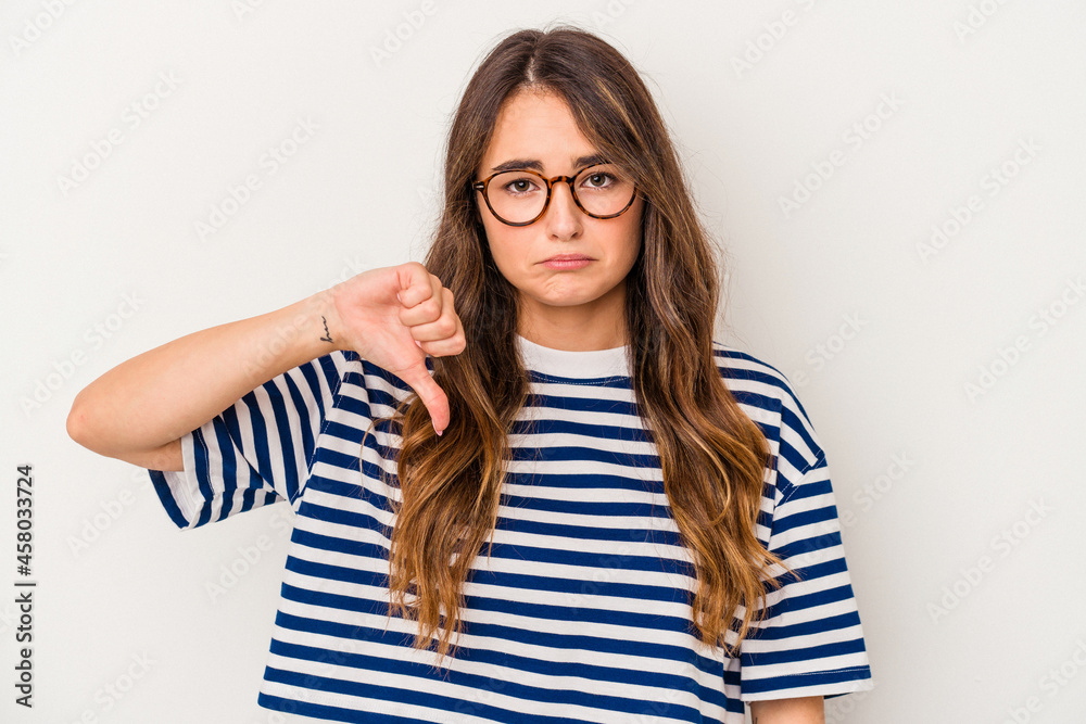 Young caucasian woman isolated on white background showing a dislike gesture, thumbs down. Disagreement concept.