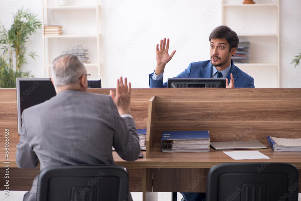 Two male employees working in the office Two male employees working in the office