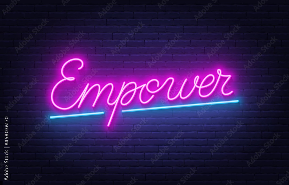 Empower neon lettering on brick wall background.