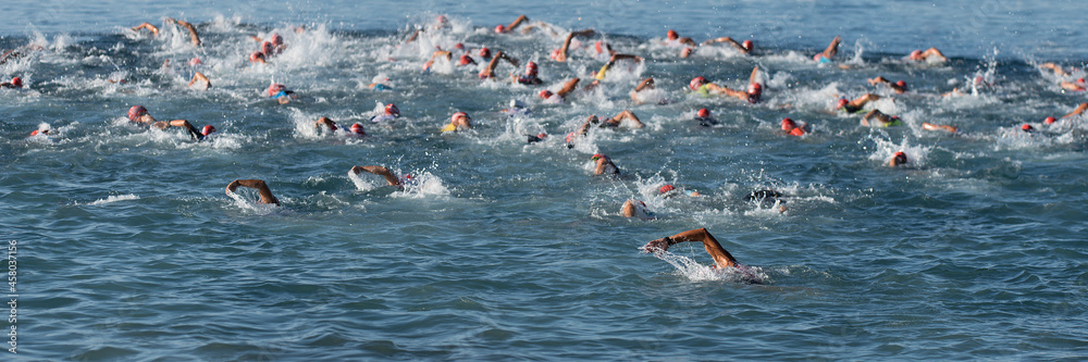 Large group of people in swimming at triathlon