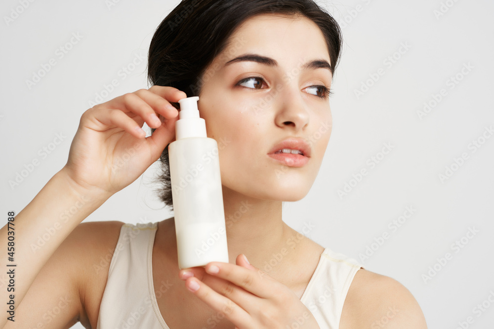 pretty brunette in white tank top cream skin moisturizing cosmetics pretty brunette in white tank top cream skin moisturizing cosmetics