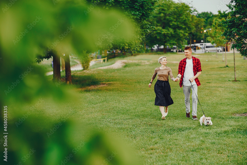 happy couple with dog in Chicago park happy couple with dog in Chicago park