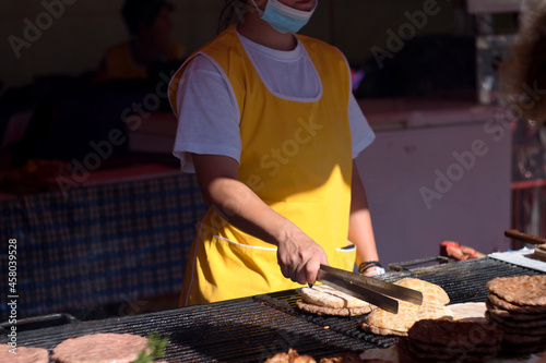 Traditional serbian street food (rostilj) - pljeskavica, cevapi, grilled chicken breast, bbq chicken wings and homemade sausages served with fresh bakery (lepinja) photo