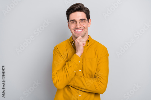 Portrait of attractive glad cheerful man manager analyst thinking isolated over grey color background © deagreez
