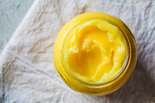 Ghee butter in glass jar, top view. photo
