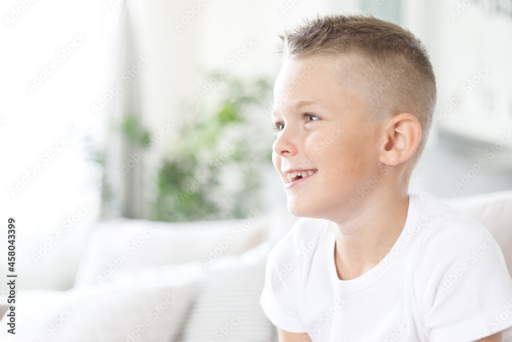 Portrait of laughing happy handsome boy, joyful child, little cheerful kid smiling on home background, copy space Portrait of laughing happy handsome boy, joyful child, little cheerful kid smiling on home background, copy space