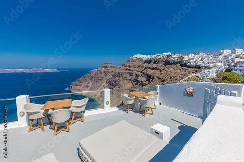 Summer vacation urban scenic of luxury famous destination. White architecture in Santorini, Greece. Perfect travel scenery with terrace sunny blue sky, sea bay. Romantic street views. Traveling Europe