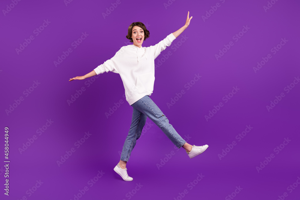 Full size photo of young beautiful smiling girl fooling around go walk enjoy weekend isolated on violet color background Full size photo of young beautiful smiling girl fooling around go walk enjoy weekend isolated on violet color background