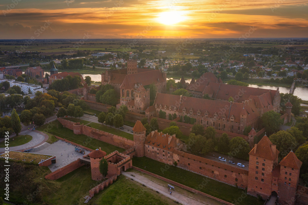 Beautiful Malbork castle over the Nogat river at sunset, Poland