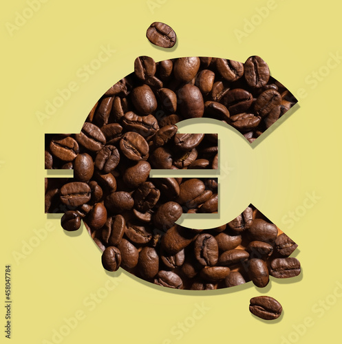 euro sign formed of coffee with yellow background.