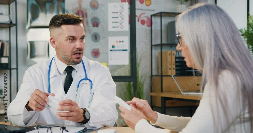 Male doctor talk to middle agge unhealthy female patient during visit in private clinic. Male doctor talk to middle agge unhealthy female patient during visit in private clinic.