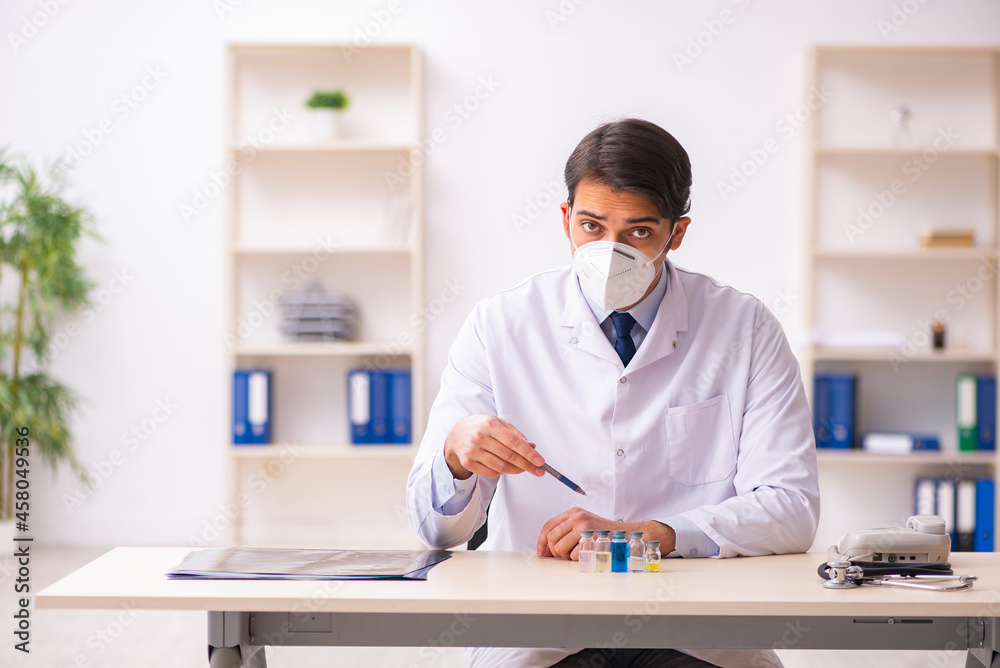 Young male doctor in vaccination concept Young male doctor in vaccination concept