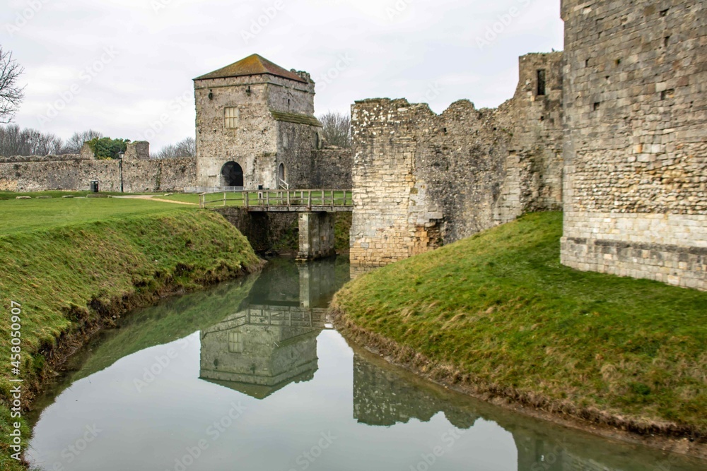 Porchester Castle England reflecting into the moat the most impressive and best preserved of the Saxon shore forts