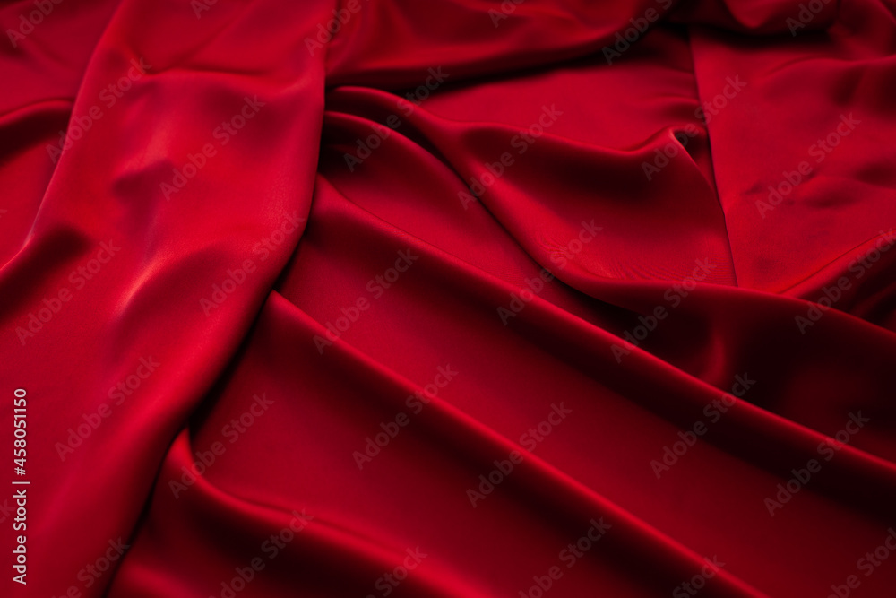 Red fabric texture background. Silk satin folds Red fabric texture background. Silk satin folds