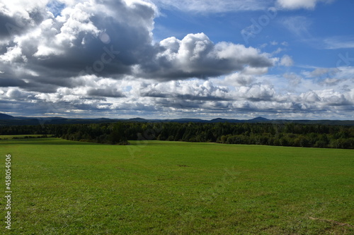 A green field under a cloudy sky  Sainte-Apolline  Qu  bec  Canada