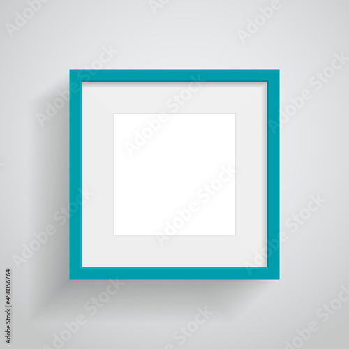 Turquoise frame with soft shadow hanging on white room wall for text or picture
