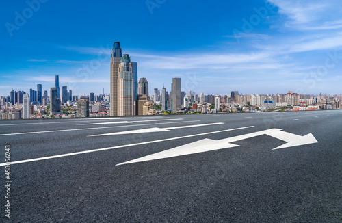 Panoramic skyline and empty asphalt road with modern buildings