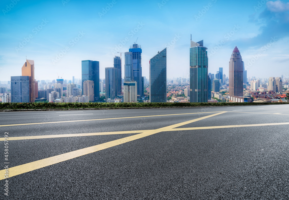 Panoramic skyline and empty asphalt road with modern buildings