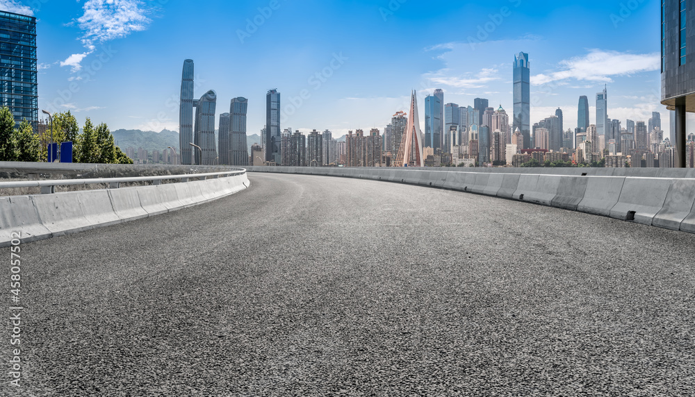 Panoramic skyline and empty asphalt road with modern buildings