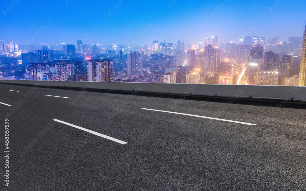 Panoramic skyline and empty asphalt road with modern buildings