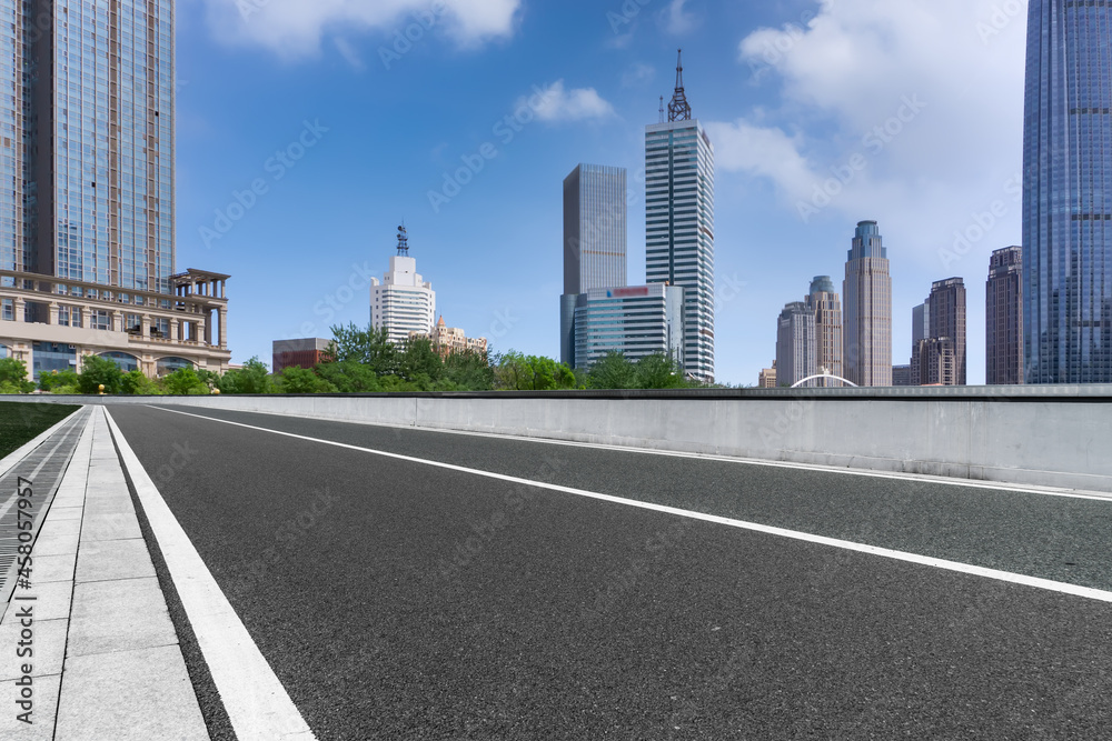 Panoramic skyline and empty asphalt road with modern buildings Panoramic skyline and empty asphalt road with modern buildings