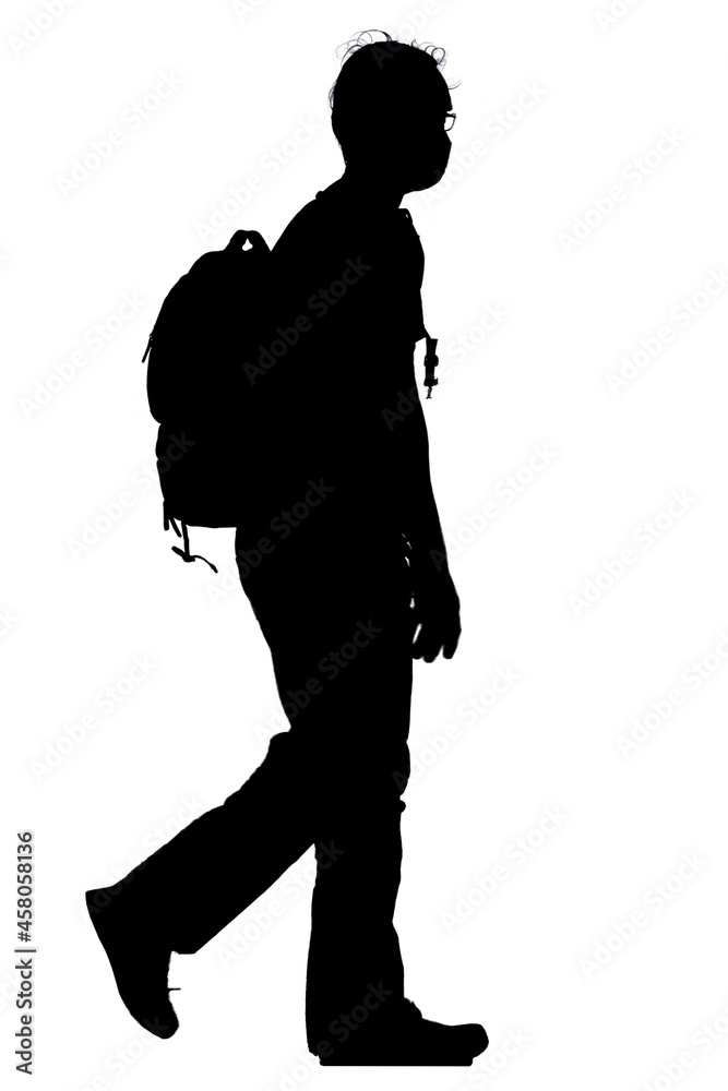 Fototapeta premium Shadow of a male tourist wearing glasses wearing a mask and carrying a backpack, side view, isolated vector silhouette, with clipping path