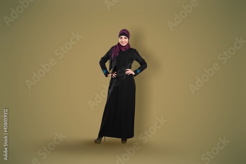 Full length young arabian muslim woman in abaya hijab photo
