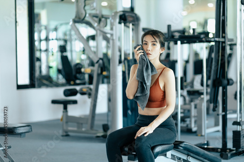 sport woman resting after workout and wipe the sweat by towel. sport and workout concept.