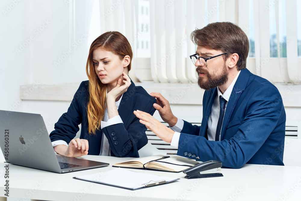 business man and woman teamwork in the office with laptop professionals business man and woman teamwork in the office with laptop professionals