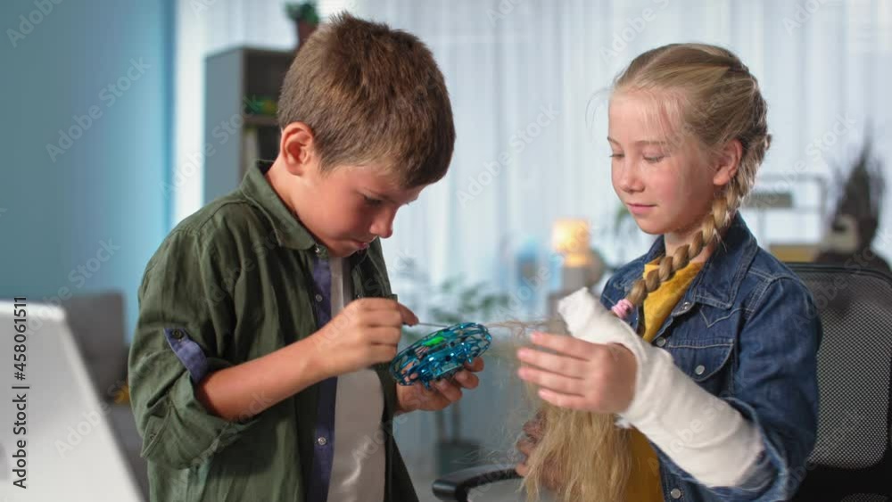 children get hair from a flying toy, beautiful girl with long white hair got entangled in mini quadcopter during the game at home children get hair from a flying toy, beautiful girl with long white hair got entangled in mini quadcopter during the game at home