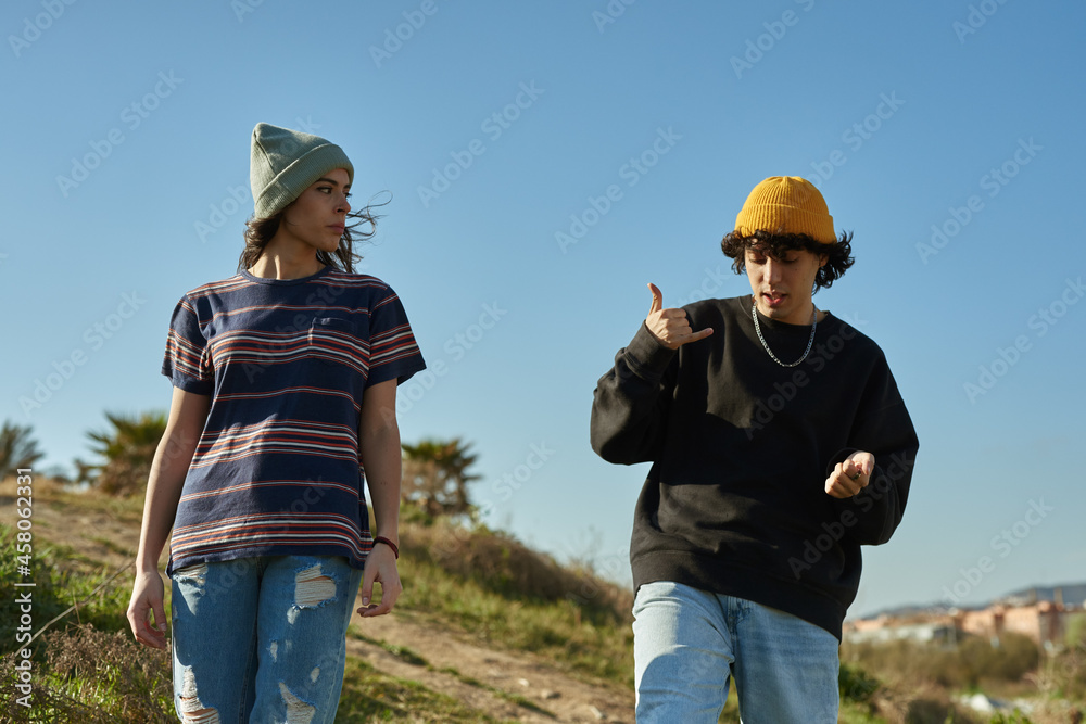 Two free young people walking down a hill Two free young people walking down a hill