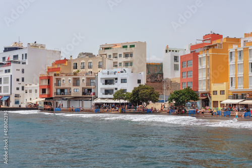 hot summer day with tourists enjoying walks along the boardwalk or chilling at the various terraces and outdoor pubs  El Medano  Granadilla de Abona  Tenerife  Canary Islands  Spain