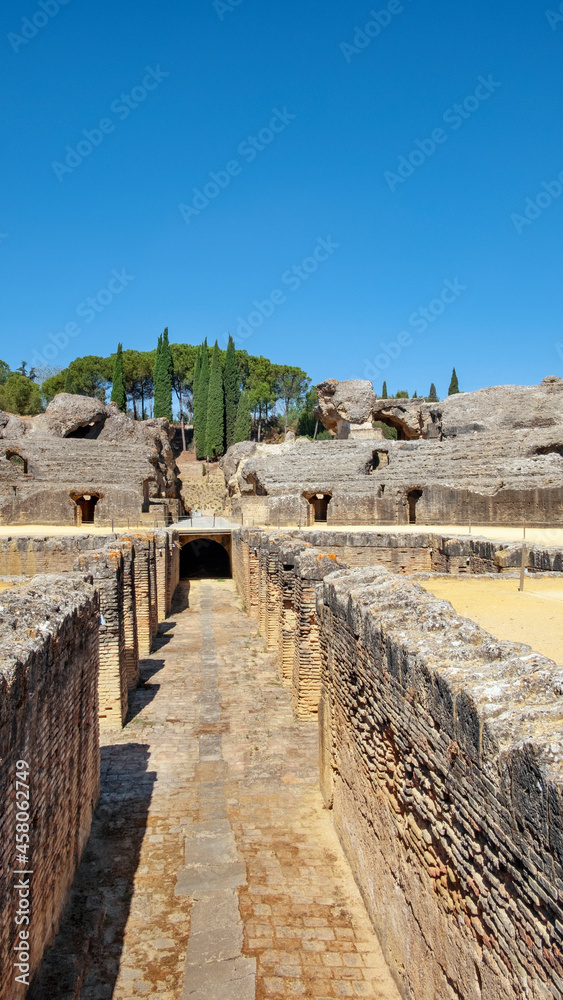 Ruins of the splendid amphitheater, part of archaeological ensemble of Italica, strategic city in Roman Empire and birthplace of Emperors Trajan and Hadrian, in Santiponce, Seville, Andalusia, Spain