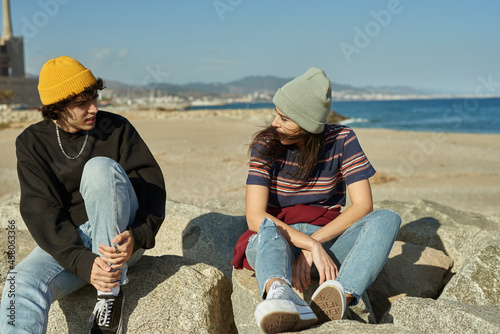 Fotobehang Two riveted young people sitting on rocks