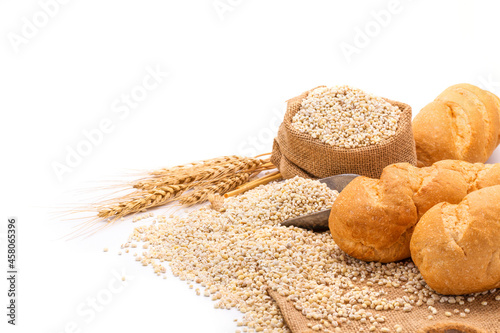 Delicious organic bread with wheat ears and wheat grains There is space to copy text. On a white table top in a rustic kitchen - top view