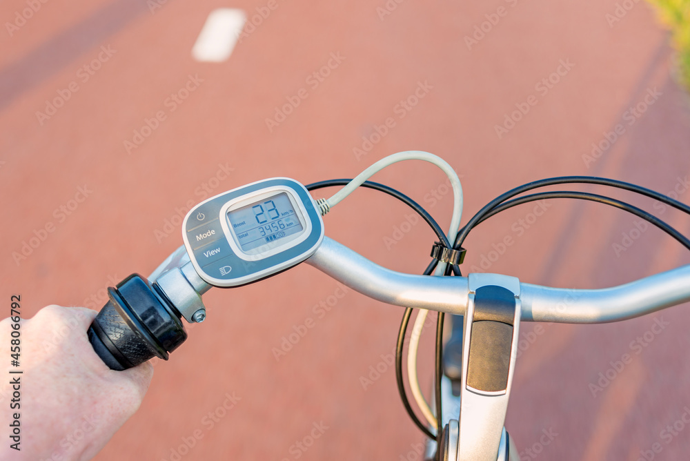 First person perspective on Control Panel on Handlebar of Electric Bicycle while driving on Bicycle lane
