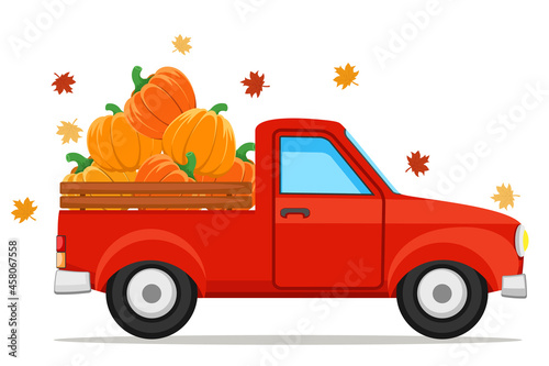 Pumpkins in a red pickup truck and autumn leaves