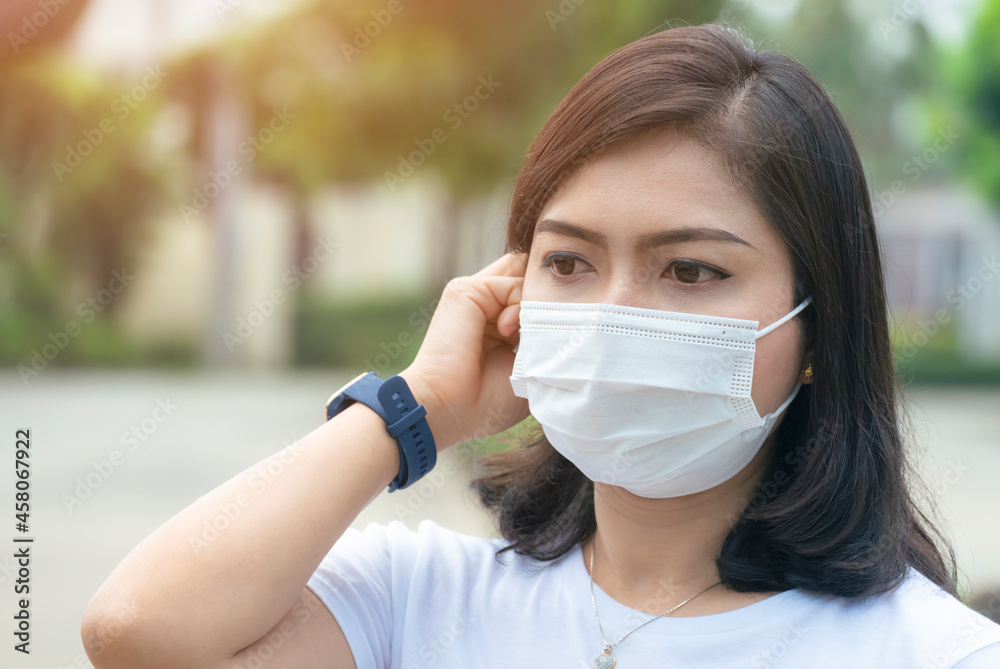 Portrait of young Asian woman wearing protective face mask in outdoors area Portrait of young Asian woman wearing protective face mask in outdoors area