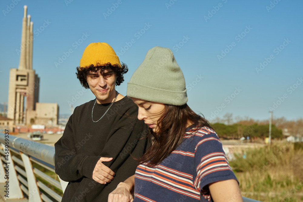 Young couple having a discussion on a bridge Young couple having a discussion on a bridge