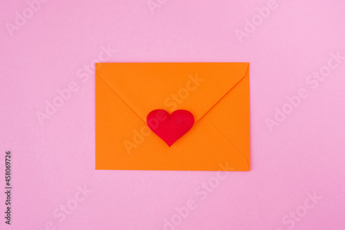Red heart and envelope on pink