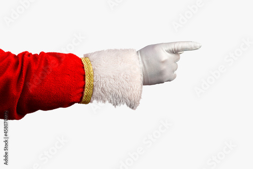 Photo of Santa Claus gloved hand in pointing gesture. Santa Claus pointing his fingers over red. Hand and arm only in horizontal format. Image can be rotated in any direction to fit your design.