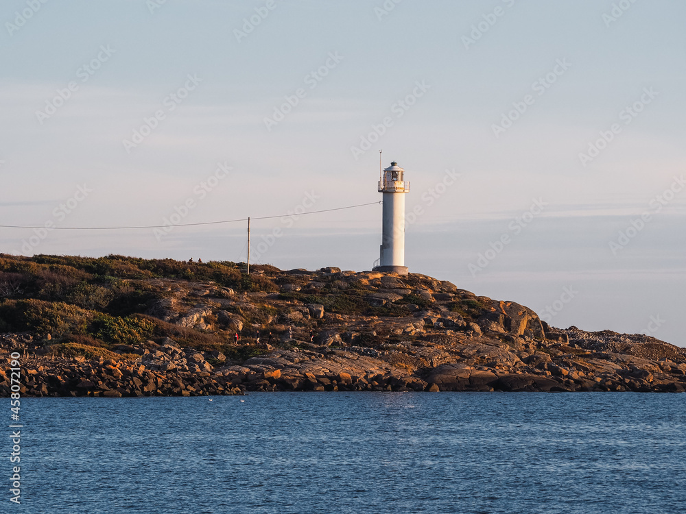 Lighthouse on the coast during sunset over the sea in Varbergs Sweden