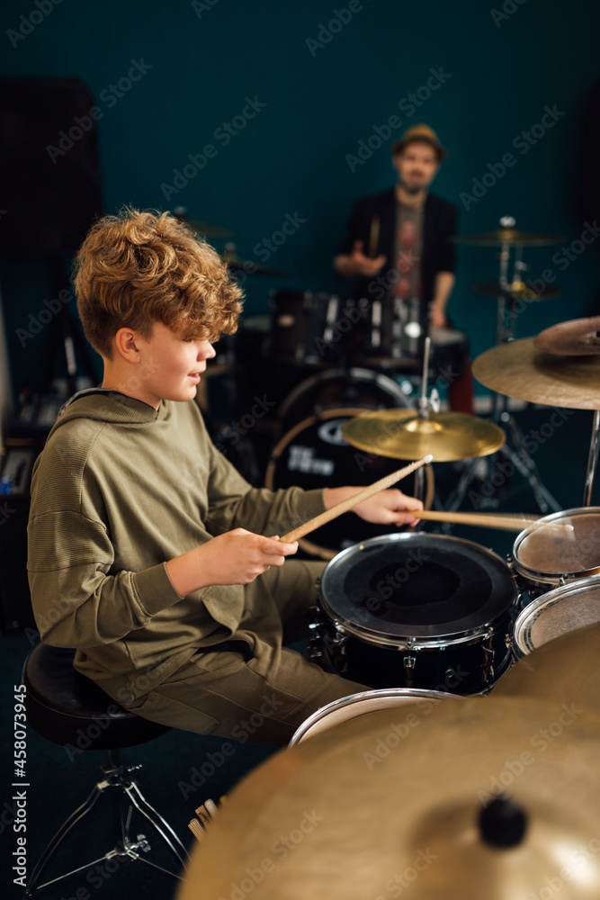 Boy at music school learning to play drums. Boy at music school learning to play drums.