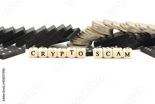 Crypto or cryptocurrency scam concept with coins and letter cubes on white background photo